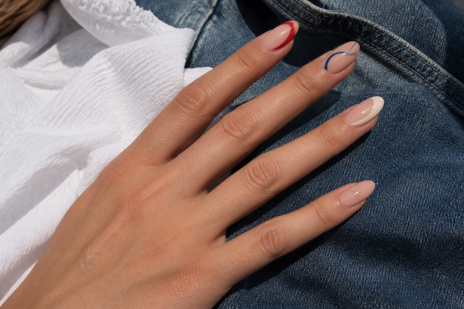 Tomato red, cream and navy manicure with a red line grid accent